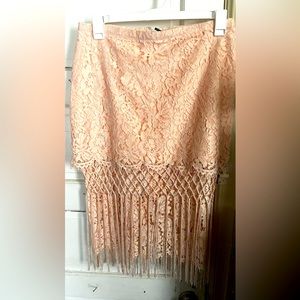 This is a pink lace skirt with fringe on the bottom!